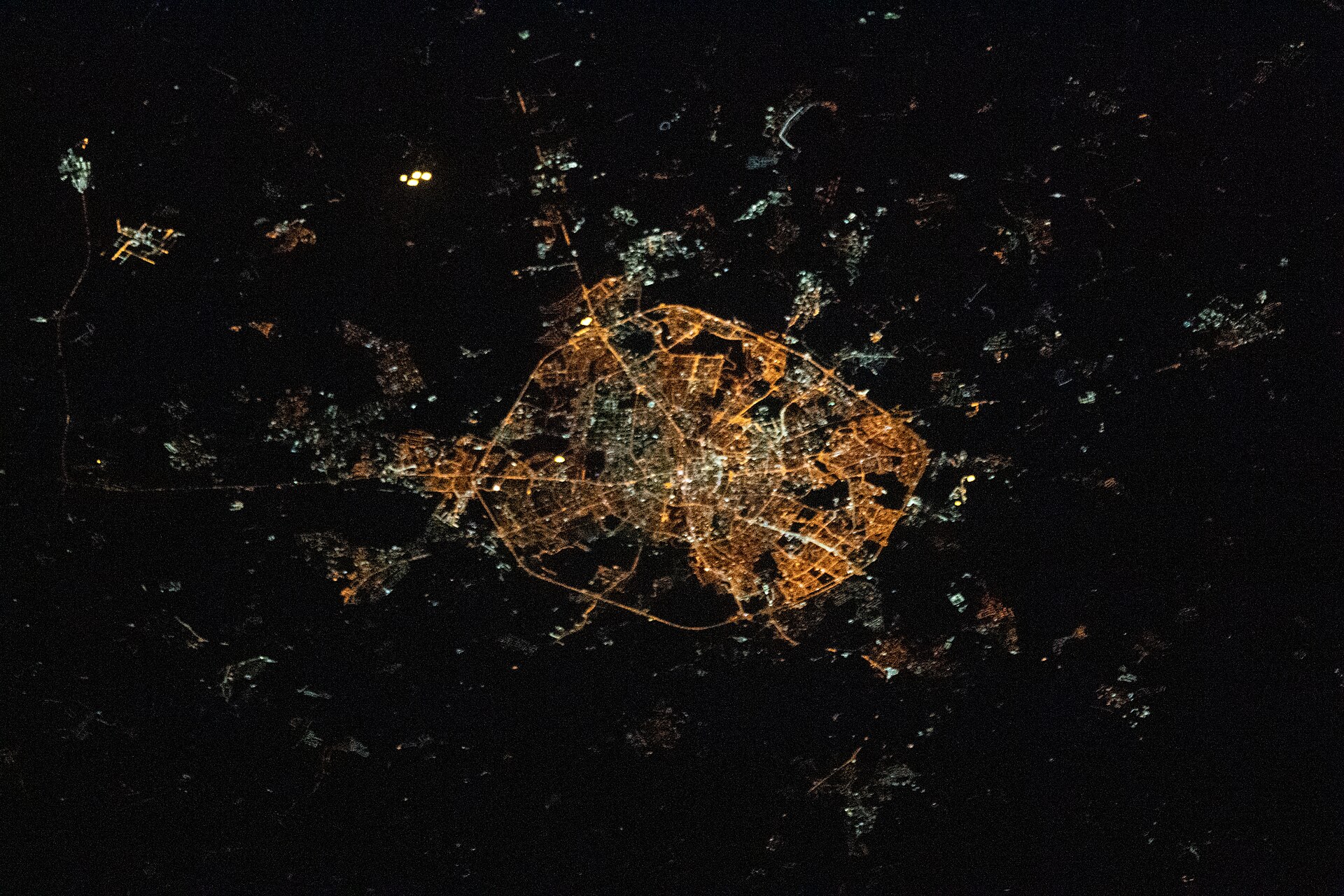 A city at night, photographed from the International Space Station